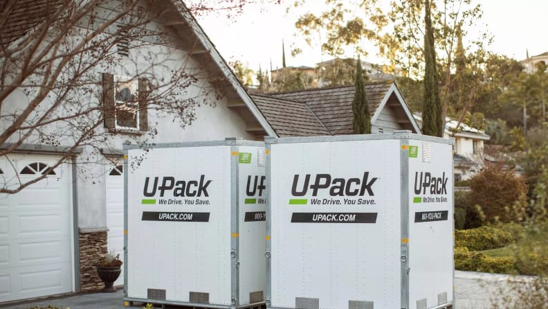 Two portable storage cubes in front of a driveway