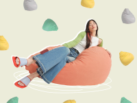 Person lounging sideways on beanbag chair surrounded by assorted colorful beanbags.