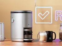 A smart Spinn Coffee maker surrounded by coffee cups and coffee grounds.