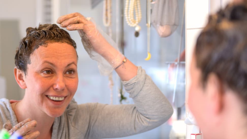 A photo of a woman dyeing her hair.