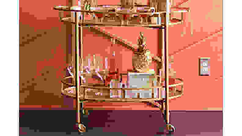 A gold Eliza bar cart