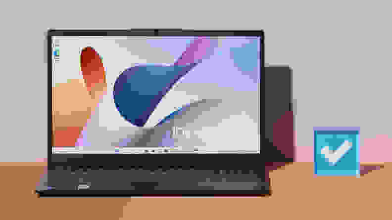 An open and powered on laptop against a pastel purple background.