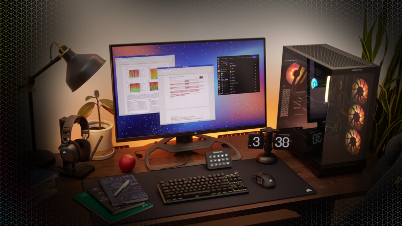 A modern gaming and work desk setup featuring a Corsair headset, RGB-lit PC, widescreen monitor, and mechanical keyboard.