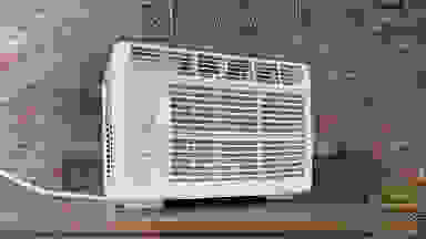 The HomeLabs HME020003N Window Air Conditioner on display on top of a table in the Reviewed labs.