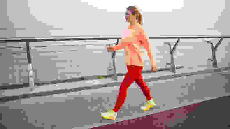 woman walking along a bridge