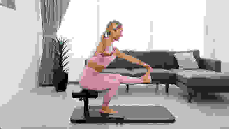A woman doing pistol squats with the BaseBench.