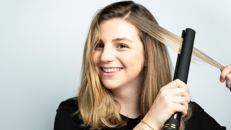 The author using the Hot Tools flat iron.