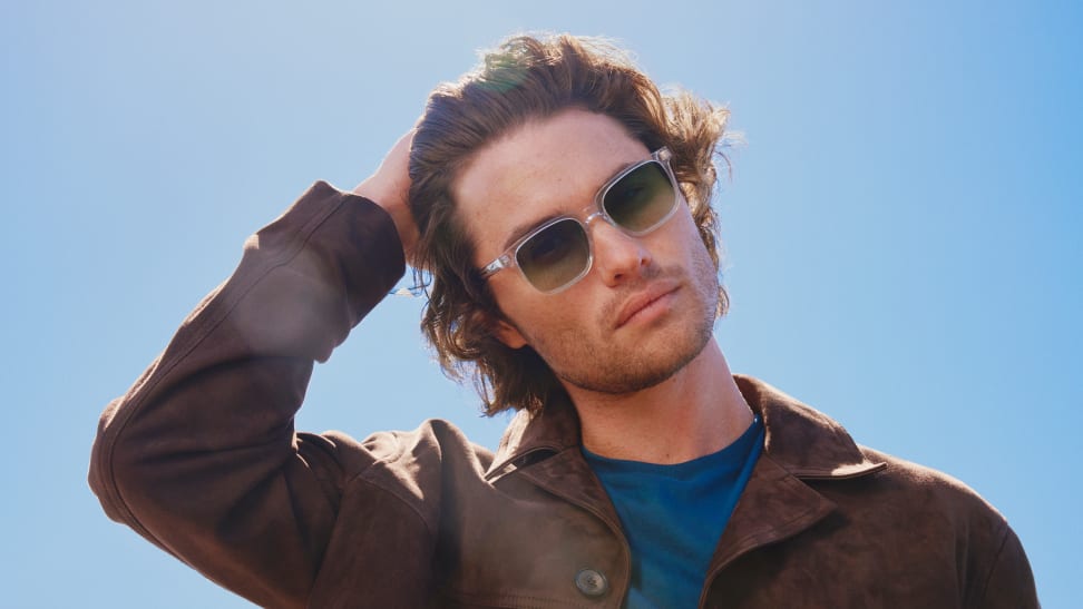 Chase Stokes Outer Banks actor wearing sunglasses and brown jacket