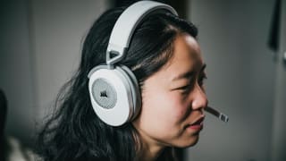 A person wears a white pair of headphones.