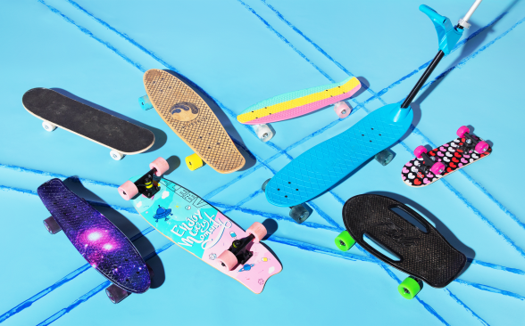 An assortment of beginner and kids' skateboards on a turquoise background