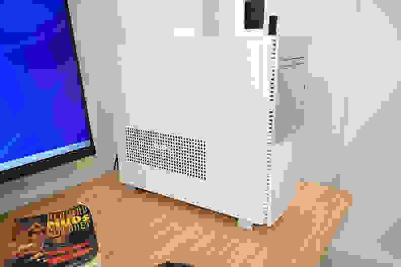 A white desktop computer tower sits on a desk.