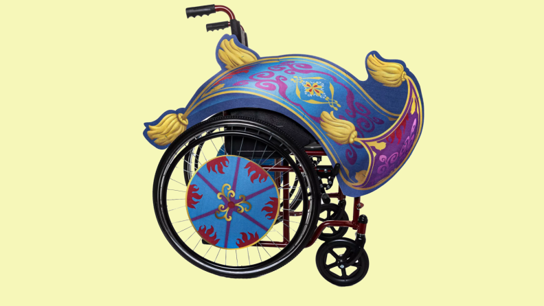 A magic carpet costume wrapped around a wheelchair on a yellow background