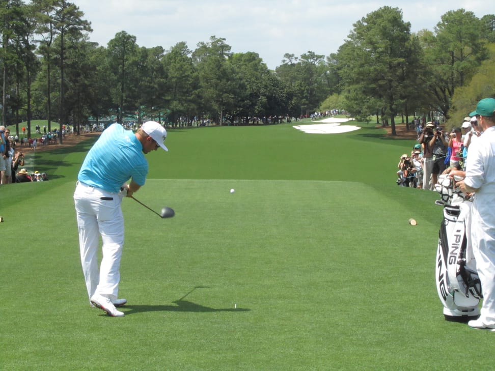 A golfer tees off at the Masters golf tournament