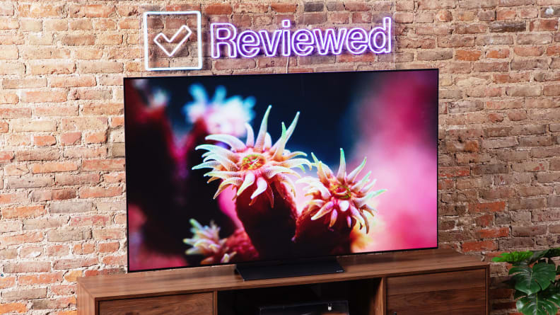 The LG C3 OLED TV displaying colorful, 4K content in front of a brick wall