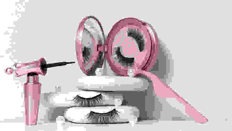 A set of magnetic eyelashes with the corresponding magnetic liner and tweezers staged on a white background.