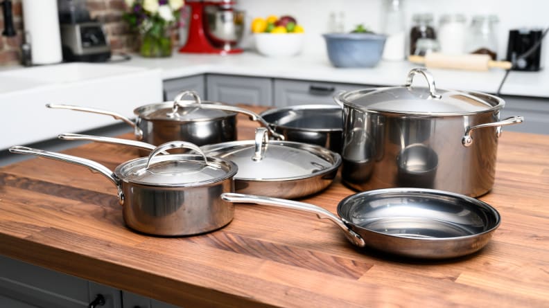 Pots and pans from the Hestan NanoBond 10-piece cookware set sit on a kitchen counter.