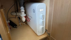 Waterdrop G3P800 reverse osmosis system installed under a kitchen sink with visible plumbing connections.