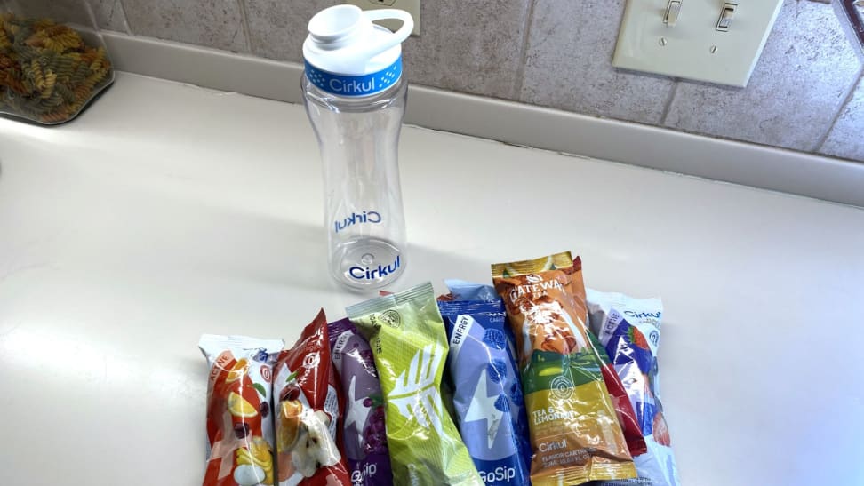 Cirkul water bottle and a variety of packaged flavor cartridges.