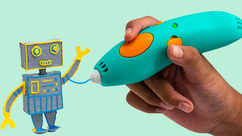 Robot next to a hand holding a 3D pen