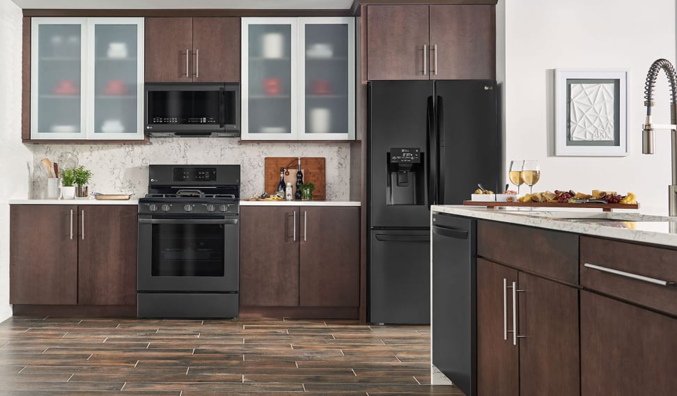 Black stainless steel appliances in a kitchen with wood cabinetry