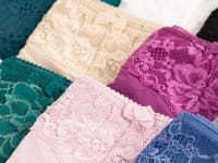 A bunch of lace women's underwear in different colors.