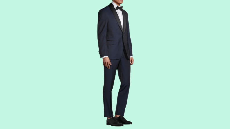 A model wearing a midnight blue tuxedo.