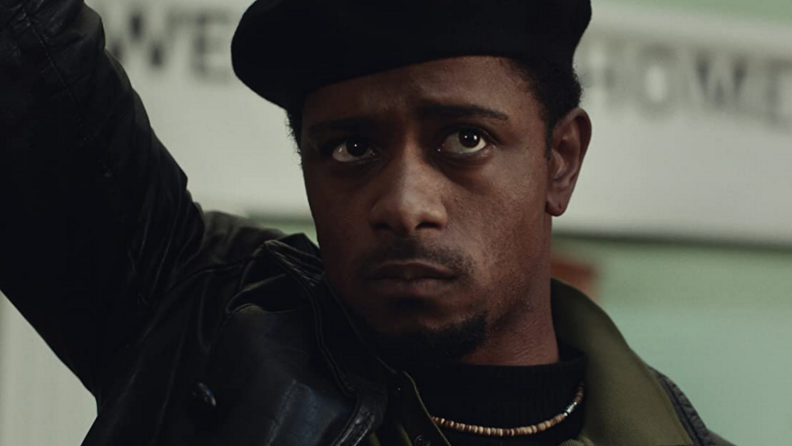 A still from the film Judas and the Black Messiah featuring Lakeith Stanfield standing with his arm leaned against a wall.