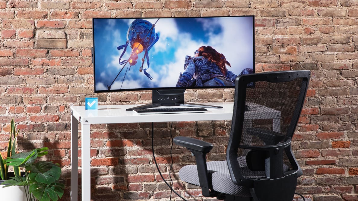 The Corsair Xeneon Flex on a white table with a brick background.
