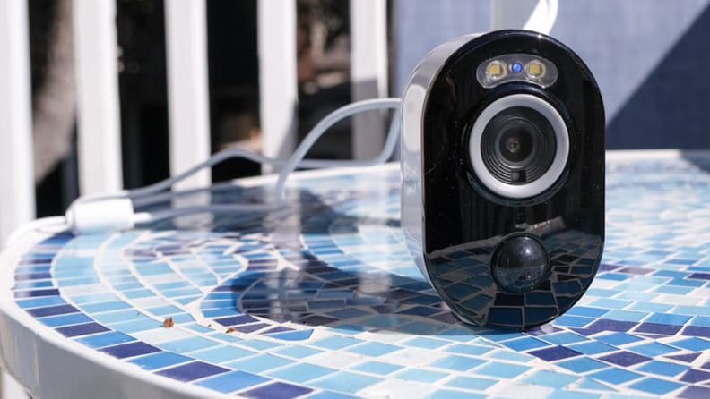 A Reolink Argus 3 Pro security camera on a table.