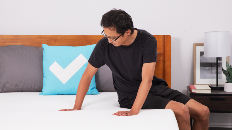 A man sitting on an Essentia Stratami mattress