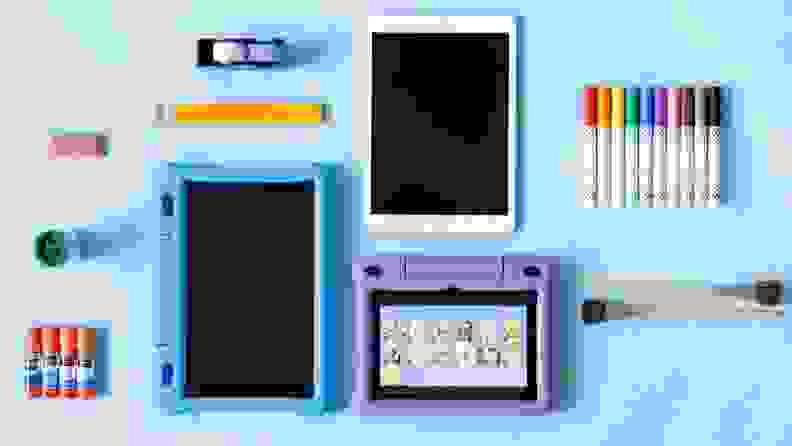A kid's tablet and accessories like markers, pencils, and brushes.