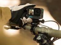 Photo of a model holding a GoPro Hero action camera.