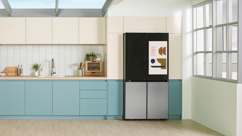 A colorful refrigerator with built-in TV screen set in a designer kitchen
