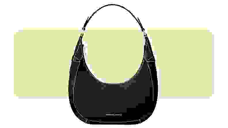 A crescent-shaped suede handbag.