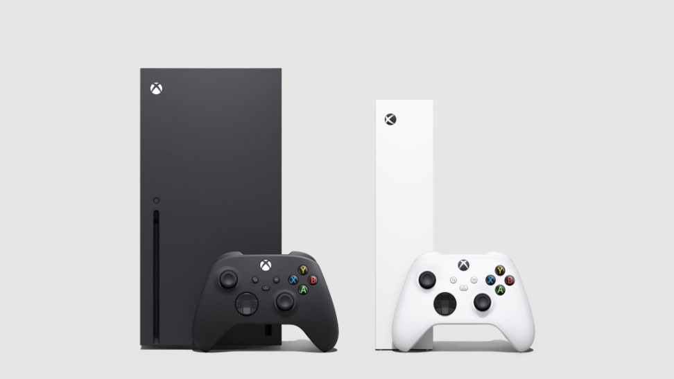 A black Xbox with a black controller in front of it next to a white Xbox with a white controller in front of it.