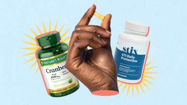 Hand holding up vitamin capsule next to two bottles of Nature's Bounty Cranberry pills and Stix UTI Daily Protection.