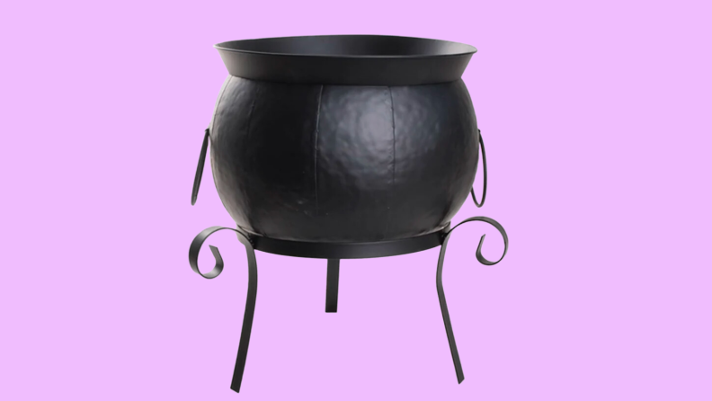 An image of a black cauldron on three slender legs.