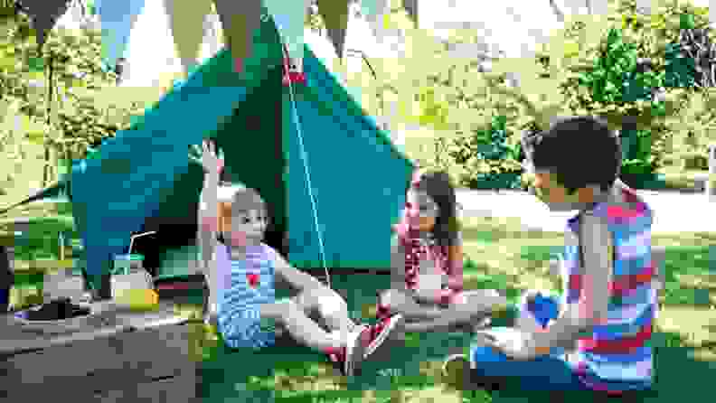 Kids enjoying a party by a small camping-style tent