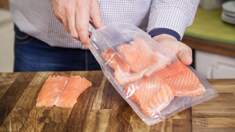 Salmon being placed in sous vide bags