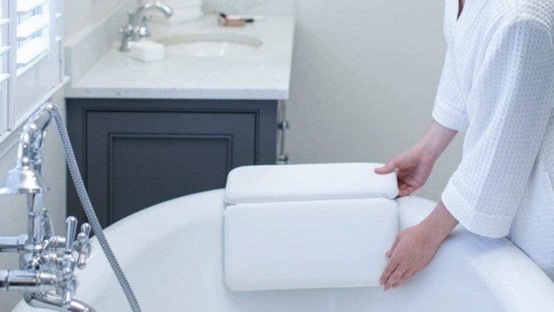 Bath tub with a suctioned bath pillow attachment on the side
