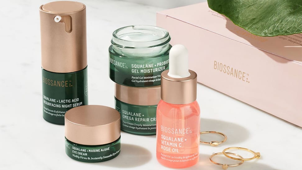Five skincare products with on display with a pink box labeled "Biossance" in the background.