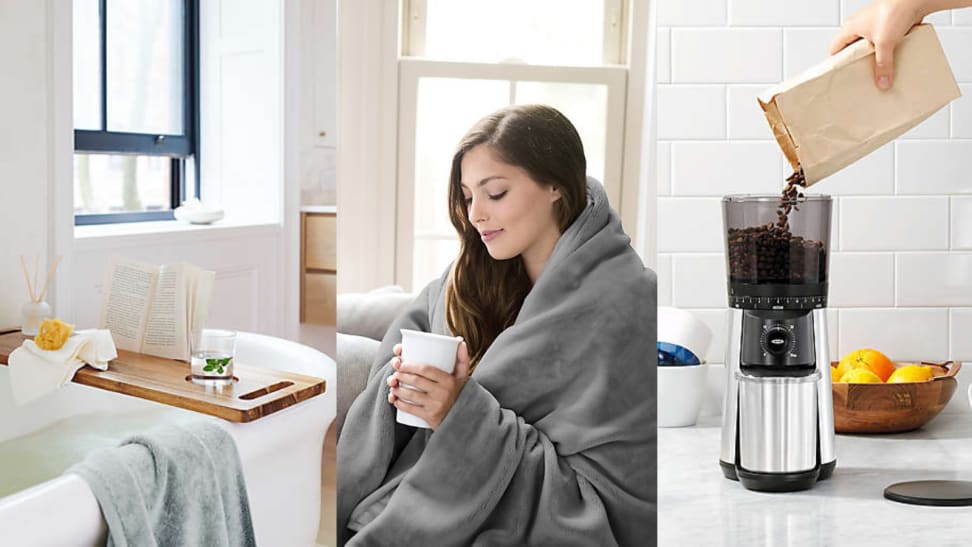 A woman snuggled under a blanket drinking a cup of coffee