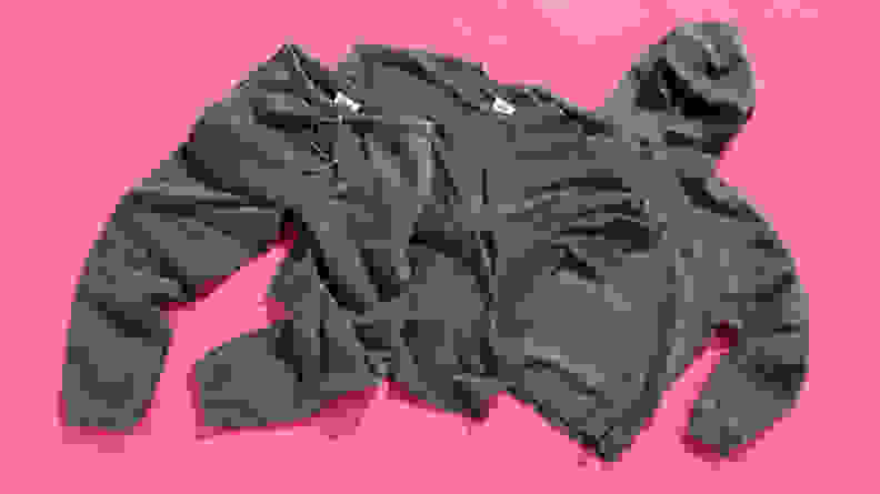 The Elwood Core Tee, Sweatpant, and Hoodie laid out on a pink background.