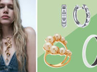 A woman wears a statement necklace, as well as a pair of studded silver hoop earrings, a gold and pearl ring, and a silver bracelet.