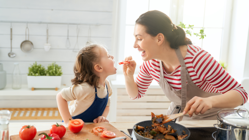 Mom and daughter in kitchen cooking together