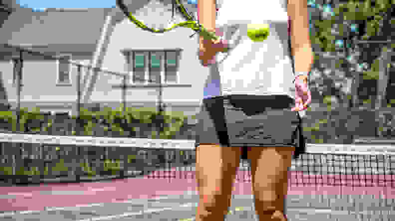 A woman wearing a tennis skirt on a tennis court.