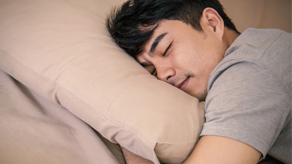 Man sleeping with face in pillow