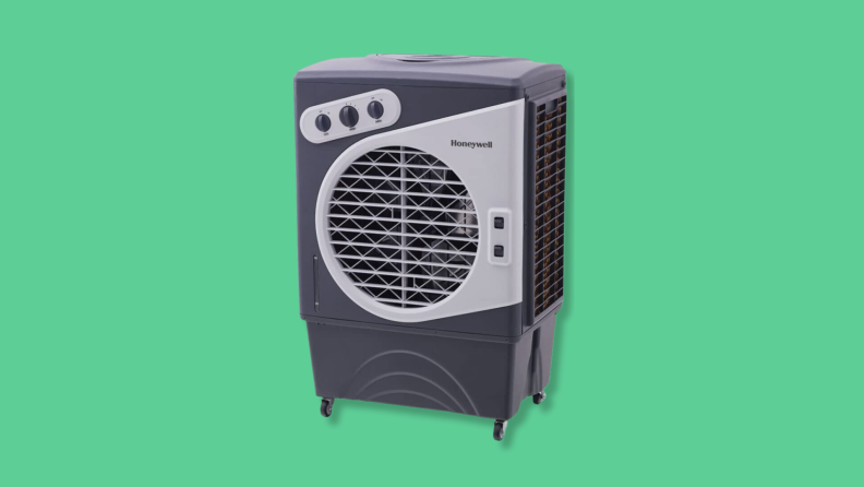 A Honeywell evaporative cooler against a green background.