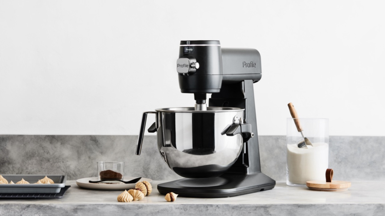 A stand mixer on a counter surrounded my cookie-making ingredients.