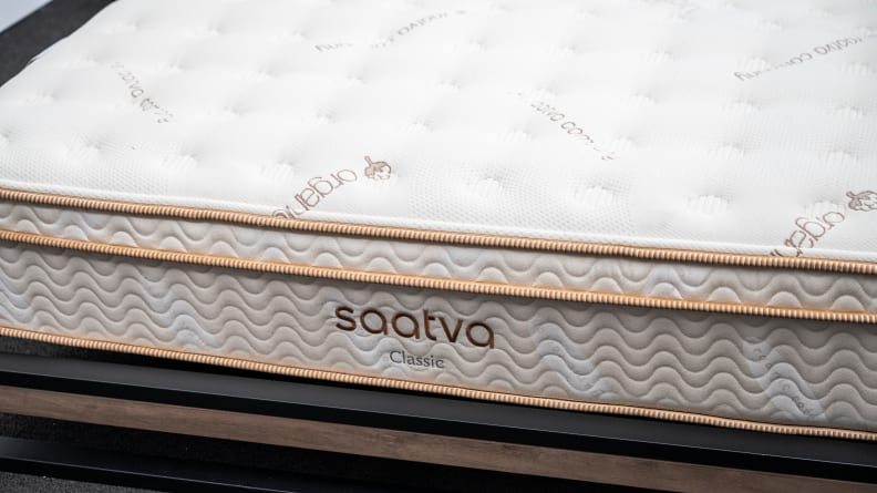 the Saatva classic mattress on a bed frame shot from close up